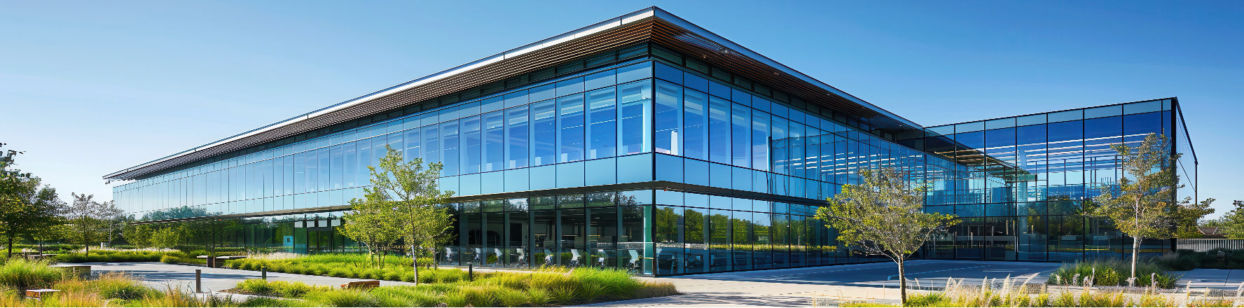 Modern glass building with a blue sky background